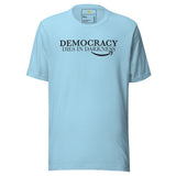 Light blue t-shirt with 'Democracy Dies in Darkness' text on a white background