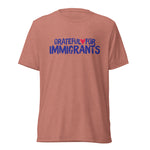 Red t-shirt with 'Grateful for Immigrants' text on a white background