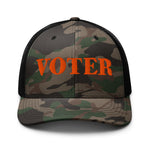 Camouflage cap with 'Voter' in orange on a white background